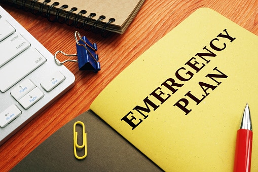 A folder with the cut-off words "emergency plan" on it.
