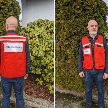 A man in an ICS vest - front and back shot