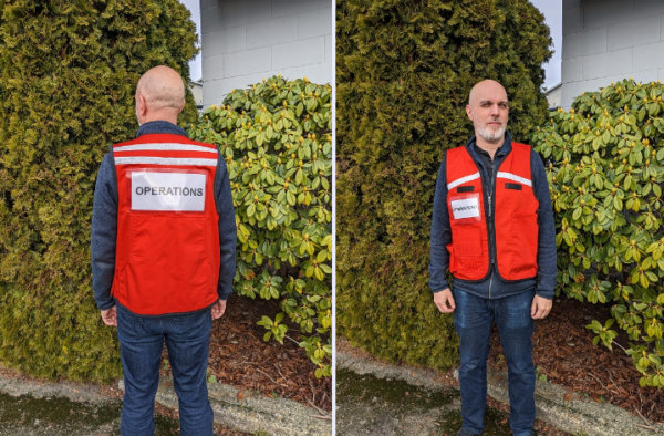 A man in an ICS vest - front and back shot