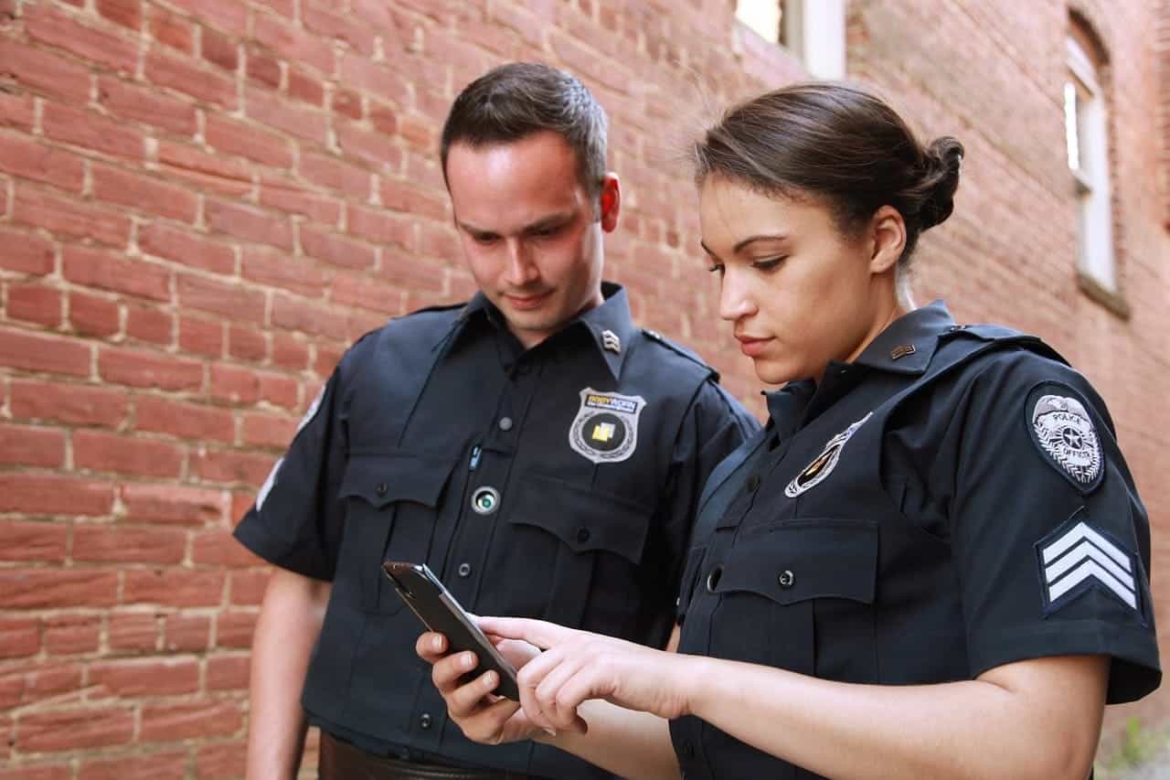 Police officers doing research on a smartphone