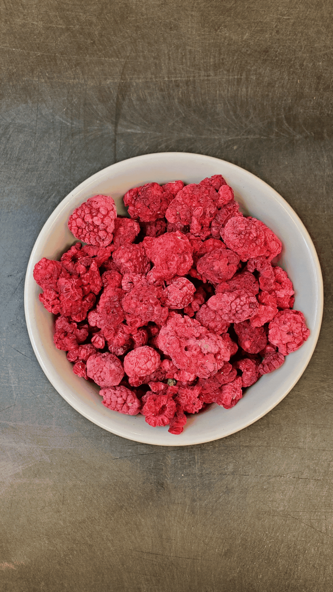 GIF of a bowl of freeze dried raspberries being eaten