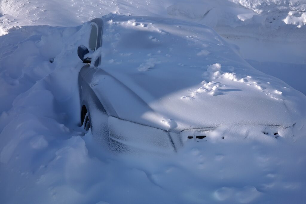 A vehicle buried in deep snow