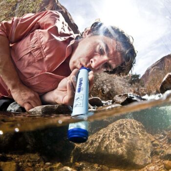 LifeStraw Personal Water Filter being used in a creek.